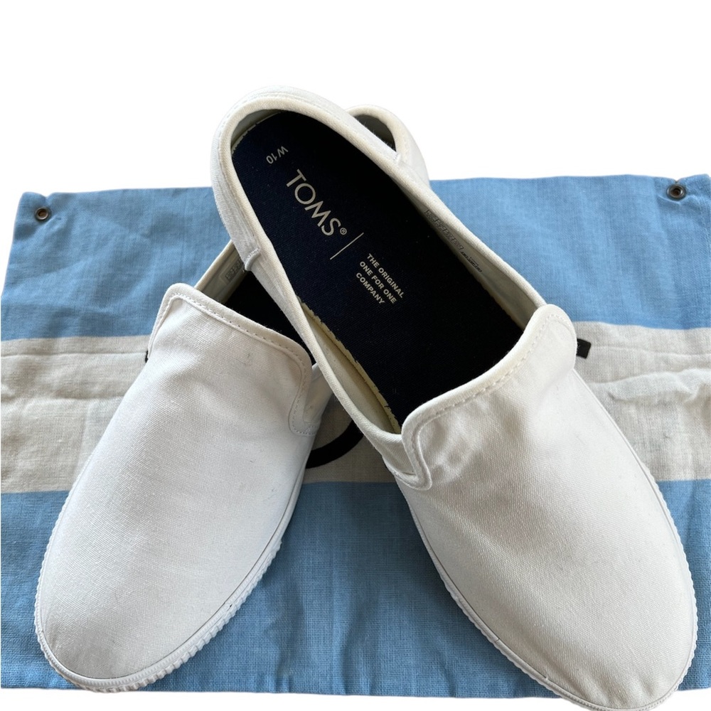 Toms White Canvas Slip Ons. Size-10. Comes with Dust bag.  Worn 2 or 3 times.